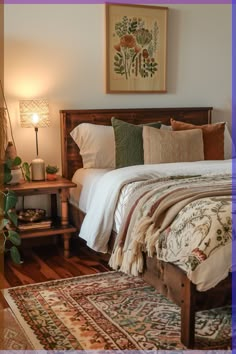 a bed sitting in a bedroom next to a wooden table with a lamp on top of it