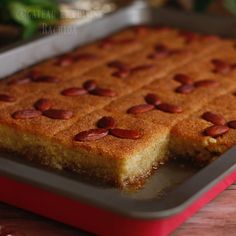 two pieces of cake sitting on top of a baking pan with almonds in it