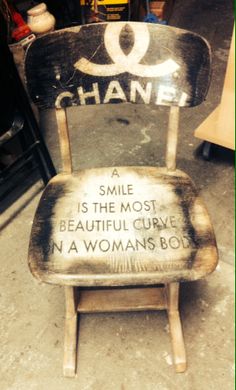 a wooden chair with a sign that says chanel