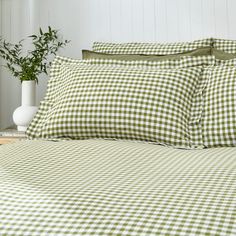 a bed with green and white checkered sheets