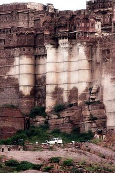 an old castle like structure on the side of a cliff