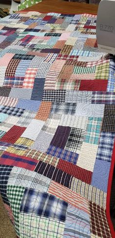 a quilt made from men's shirt scraps cut rectangles