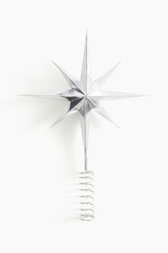 a metal star on top of a white wall