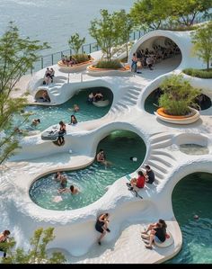 many people are swimming in the water at an outdoor pool with white walls and curved steps