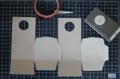 three pieces of cardboard with scissors and tape next to them