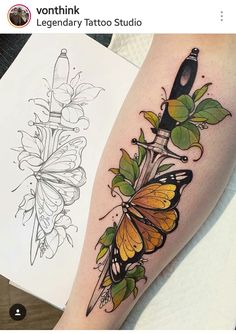 a tattoo with butterflies on it and a knife in the middle, sitting next to a piece of paper