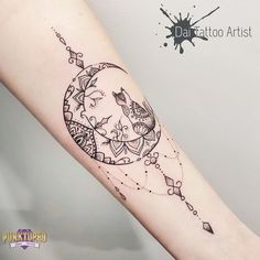 a woman's arm with a black and white tattoo design on the left forearm