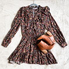 Zara Floral Dress | Fall Colors | Button Down | V-Neck | Long Sleeve | Ruffle Skirt | Elastic Waist | Sutil Metallic Thread | Size X Small Fabric: 99% Viscose 1% Metallic Vezel Flat Measurements: Elastic Waist 12” Stretches To 20” Sleeves 23” Neck To Shoulders 5” Crew Neck 7” 34” Long Casual Black V-neck Dress For Fall, Floral Print V-neck Dress For Fall, Fall Fitted Floral Print V-neck Dress, Black Mini V-neck Dress For Spring, Black Mini-length V-neck Dress For Spring, Black Mini Length V-neck Dress For Spring, Fall Floral V-neck Dress For Brunch, Chic Floral V-neck Dress For Fall, Chic Black Floral Dress For Fall