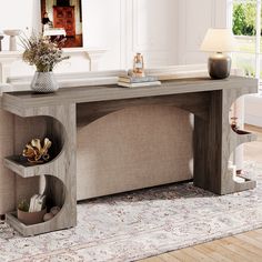 a large console table with two shelves on each side and a lamp next to it