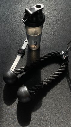 a coffee cup sitting on top of a table next to a rope