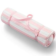 a pink and white striped baby crib mattress with ribbon on the top, rolled up