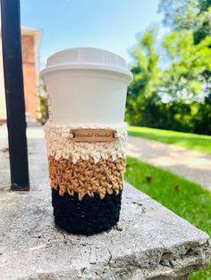 a coffee cup sitting on top of a rock