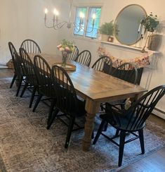 a dining room table surrounded by black chairs