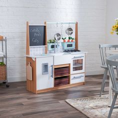 a small kitchen with an oven, table and chairs