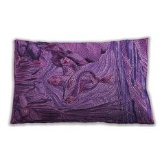 a purple pillow with an image of a woman laying on the ground in front of her