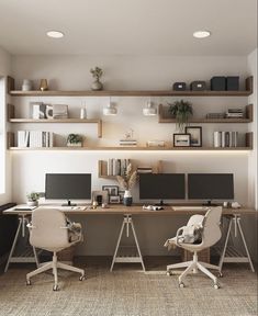 an office with two computer desks and shelves on the wall above them is shown