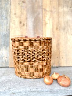 two onions sitting next to a basket on a table