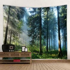 a room with a wooden floor and a wall hanging on the wall is decorated with an image of a forest