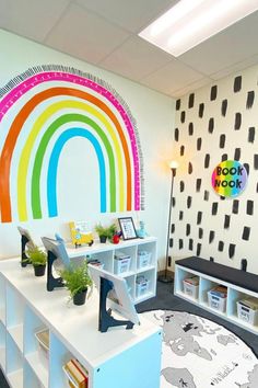 the children's room is decorated with rainbows and bookshelves for reading