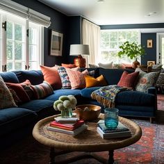 a living room filled with lots of furniture and pillows on top of a coffee table