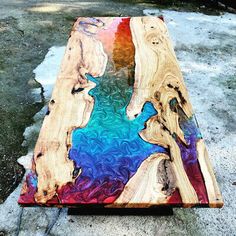 a table made out of wood with colorful paint on it