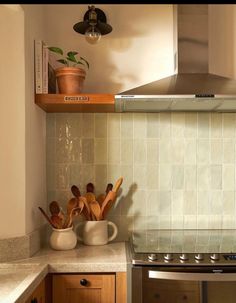 the kitchen counter is clean and ready to be used as a stove top oven with utensils on it