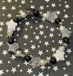 Get lost in a galaxy far away with this plastic Star beaded bracelet. Accented with glass pearl and silver colored spacer beads is sure to add an out of this world sparkle to your park day outfit!   Bracelets are available in a variety of lengths.  Pick your custom length from the drop down menu below.  All our bracelets are made with quality in mind.  With that being said, all bracelets should be treated with care while putting on, wearing, and taking off.  Keep dry. Do not swim or bath with th Pretty Bead Jewelry, Bracelet With Stars, Star Bracelet Diy, Beaded Star Bracelet, Star Bracelet Bead, Star Beads Bracelet, Silver Beads Bracelet, Alt Bracelets, Bracelet Ideas Glass Beads