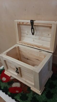 an open wooden chest sitting on top of a rug