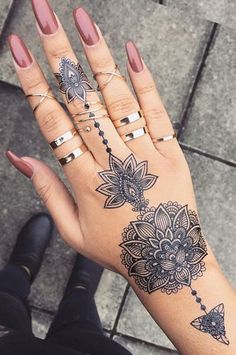 a woman's hand with tattoos on it