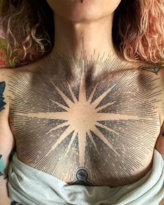 a woman with tattoos on her chest