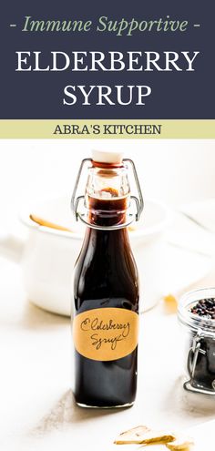 an image of elderberry syrup in a glass bottle on a table with other ingredients