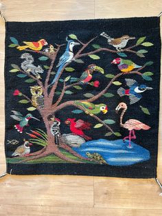 an embroidered tree with birds on it