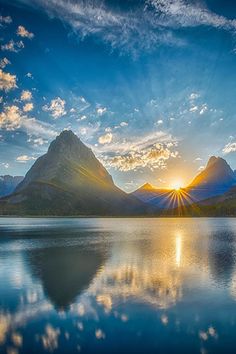 the words good evening are in front of a mountain lake with mountains and blue sky