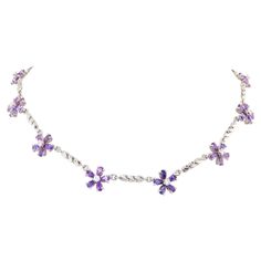 The lavender sapphire and diamond necklace features 10 flowers set with faceted drop shaped sapphires of brilliant color and crystalline texture for a total weight of 13.30 carats. The design is complete with 0.90 carats of round diamonds of top quality (F/G-VVS). The 14.50” necklace is one-of-a-kind. It was handmade in Italy in 18 carat white gold in our own workshop by maestro Scalabrì according to an original design by Ella Gafter. The item is signed EG. Purple Diamond Wedding Necklace, Luxury Purple Jeweled Necklace, Luxury Purple Diamond Cut Necklace, Purple Sapphire Necklace, Purple Diamond Necklace, Luxury Ornate Purple Necklace, Lavender Sapphire, Elegant Purple Flower-shaped Necklace, Sapphire Diamond Necklace