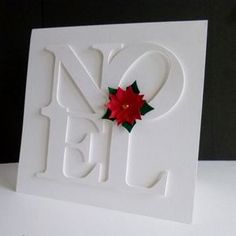 a white card with a red poinsetti on it