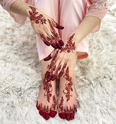 a woman with henna on her hands and feet