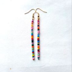 Colorful Boho Handmade Glass Seed Beaded Dangle Stick Earrings Finished With Gold Tone Hook Ear Wires Gypsy Hippie Retro Mod Nickel Free Gold Tone Hook Ear Wires With Clear Backs To Help Keep In Place Dainty Tiny Glass Seed Beads In Multi Colors, Randomly Chosen By Me To Create You A Beautiful Unique Pair Of Earrings Using The Same Bead Colors Yet Randomly Selected Approximately 3.25 Inch Length Handmade Beautiful Earrings To Wear Daily Or Give As A Gift For Christmas, Anniversary, Birthday, Val Glass Seed Bead Earrings, Minimalist Beaded Earrings, Colorful Adjustable Heishi Beaded Earrings, Adjustable Heishi Beads Earrings For Beach, Multicolor Heishi Beads Earrings With Ear Wire, Adjustable Beaded Earrings With Dangling Beads For Everyday, Multicolor Heishi Beads Jewelry With Dangling Beads, Handmade Multicolor Heishi Beads Earrings, Adjustable Beaded Earrings With Dangling Beads For Beach