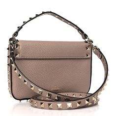 This is an authentic VALENTINO GARAVANI Grainy Calfskin Rockstud Crossbody Pouch in Poudre. This bag is crafted of grained calfskin leather in beige. The bag features a light gold studded leather top handle and a matching removable shoulder strap. The studded crossover flap opens with a magnetic snap to a beige suede interior with leather card slots. Pink Suede, Studded Leather, Gold Studs, Leather Top, Leather Handle, Magnetic Closure, Body Bag, Valentino Garavani, Cross Body