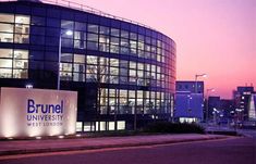 an office building lit up at night with the name brunel university