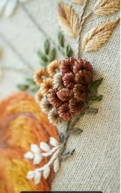 a close up view of some flowers on a piece of fabric with text overlay