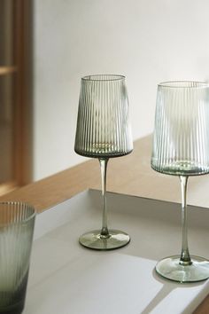 two glasses sitting next to each other on a counter