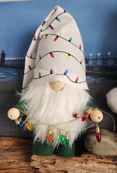 a small gnome with white hair and lights on his face is sitting on a piece of wood