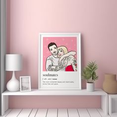 a pink wall with a white shelf holding a framed poster and a potted plant