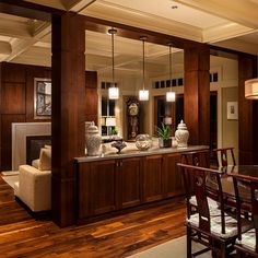 a dining room and living room with wood flooring in an upscale house style home