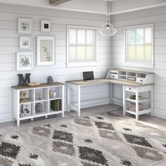 a computer desk sitting on top of a white rug