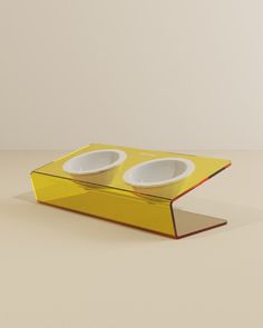 an open book with two bowls in it sitting on a table top next to each other