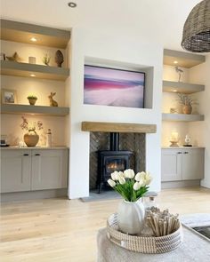 a living room filled with furniture and a fire place in the middle of it's walls