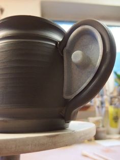 a close up of a pottery pot on a table