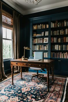 a desk with a laptop on top of it in front of a bookshelf