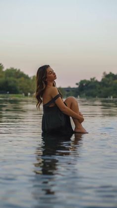 a woman sitting in the water with her legs crossed